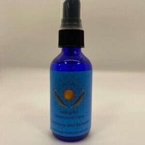 A blue bottle of lotion sitting on top of a table.