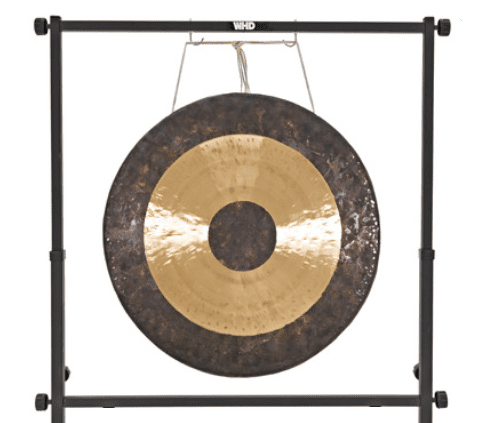 A gong hanging on the wall with a metal frame.