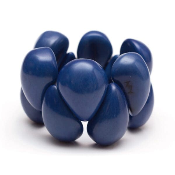 A blue Tagua Raindrop Bracelet is shown in the image