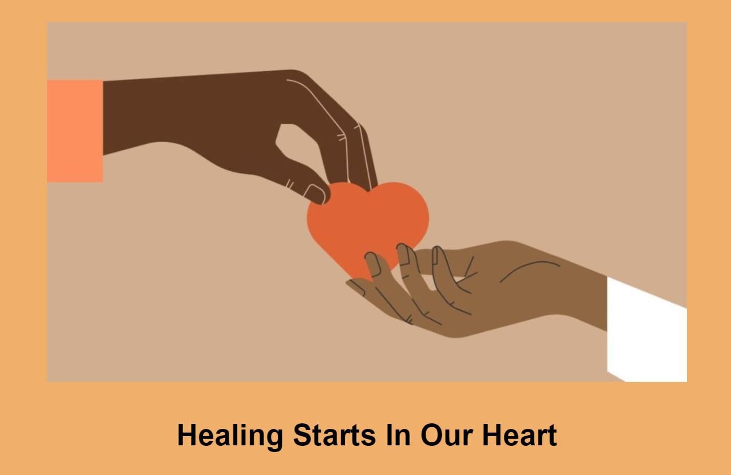A person is holding an orange heart in their hand.
