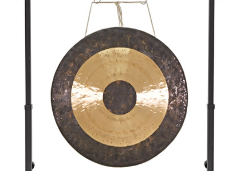 A gong hanging on the wall with a metal frame.